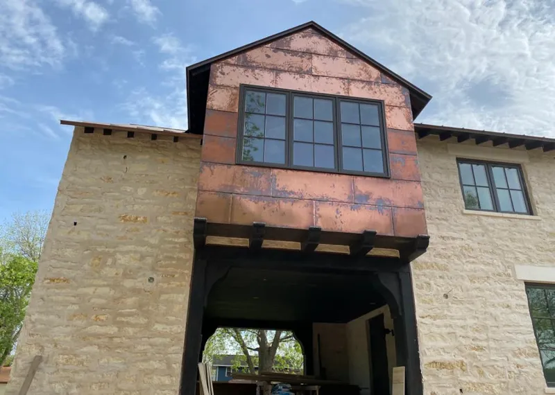 Copper metal panel facade on a stone building for Skylight Installation in Sudden Valley